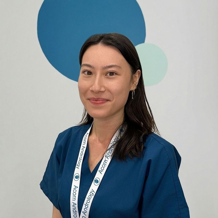 Kerry, a reproductive technologist, smiling in a professional portrait against a light background with blue circular shapes.